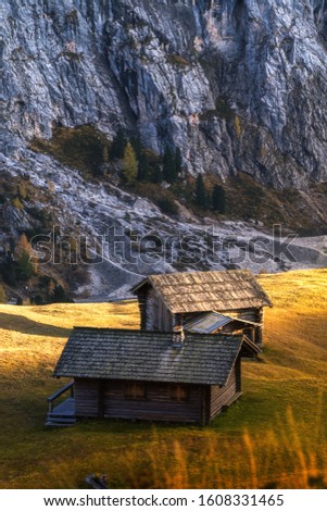 Italy. Abandoned cabins in Dolomites alps mountains before sunset.