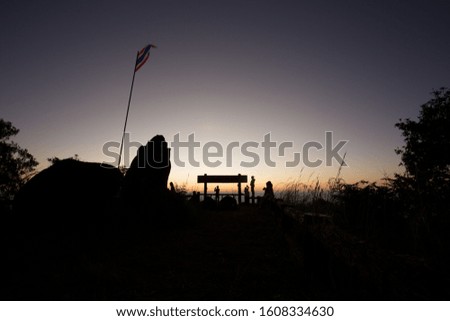 Silhouette movement Thai flag and people on hilltop view point