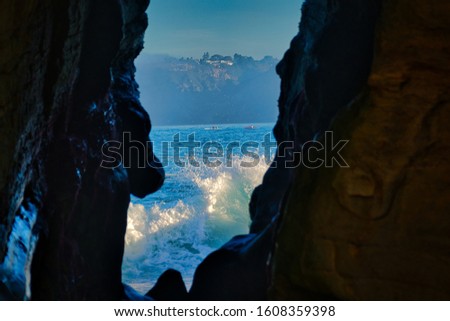  KAYAKERS IN LA JOLLA SEEN THROUGH THE SEA CAVE