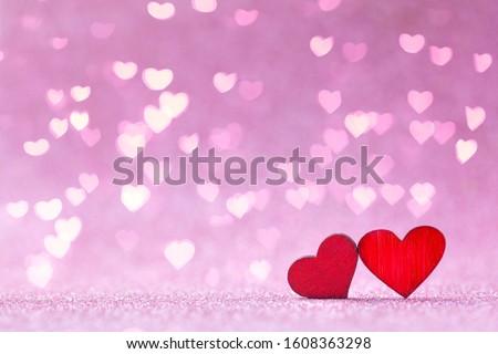 Valentine's day greeting card. Two red wood Heart shapes on abstract pink background in love concept.