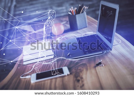 Desktop computer background in office and start up theme hologram drawing. Double exposure. Startup concept.