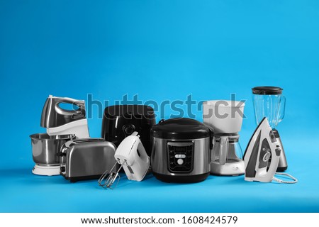 Set of different household appliances on light blue background Royalty-Free Stock Photo #1608424579