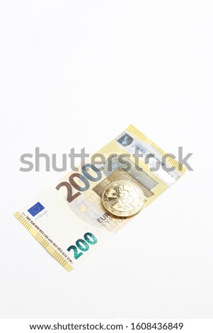 Euro banknotes and bitcoin coin