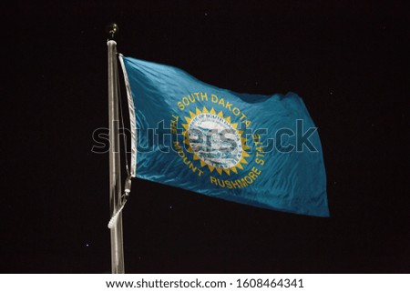 South Dakota flag blowing in the wind at night