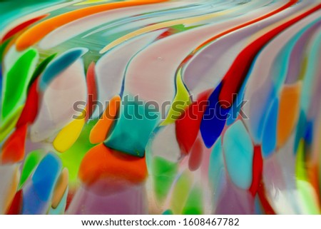 Multi-coloured glass installation forming abstract colourful pattern.