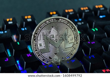 Coin cryptocurrency monero close-up of the colour-coded keyboard background