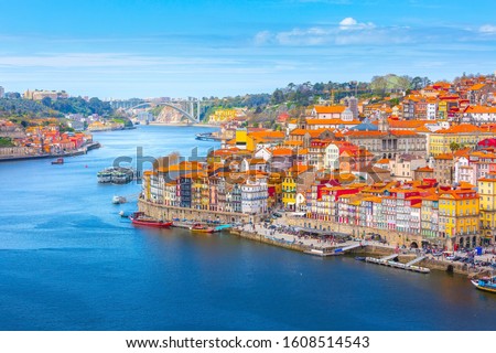 Porto, Portugal old town ribeira aerial promenade view with colorful houses, Douro river and boats Royalty-Free Stock Photo #1608514543