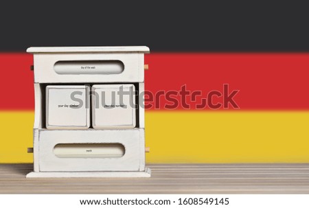 Wooden retro calendar with free space for a date on the background of the flag of Germany. Template for writing dates of national holidays of Germany with free text space