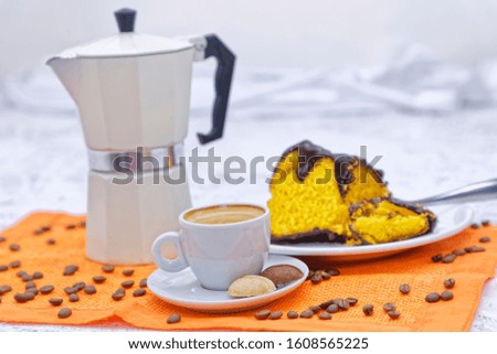 Coffee served in Italian coffee maker, with chocolate-covered carrot cake, biscuits.