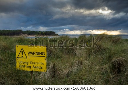 Warning sign on a scenic beach.