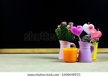 The Valentines Day concept with heart-shaped candles and flowers.