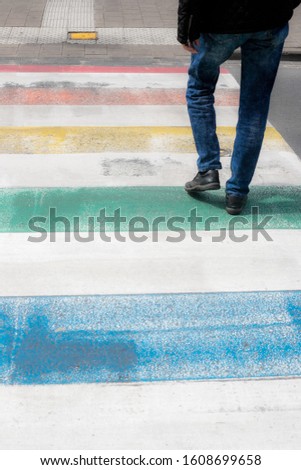 A man crossing a colorful zebra crossing - a creative picture for wallpapers and backgrounds