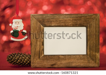 santa claus and pine cone on red background christmas card