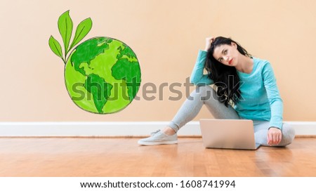 Save earth concept with young woman using a laptop computer