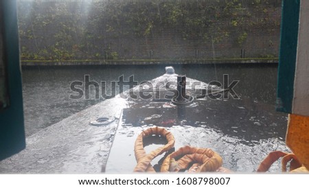 From the perspective of the bow of a canal boat in the rain