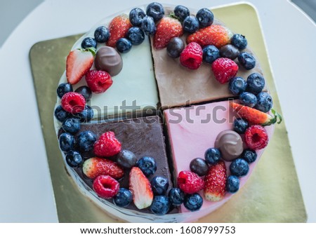 Mix Cakes with berries and chocolate candies on a golden backing. Picture for a menu or a confectionery catalog.