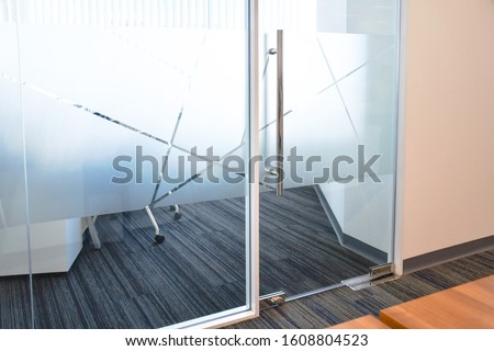 Frosted film glass sticker cut in pattern, Glass Film Design, Privacy in work place, Modern office meeting room or manager room concept. Glass wall idea for interior. Royalty-Free Stock Photo #1608804523