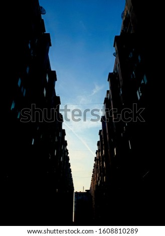 Parallel apartment buildings and the sky.