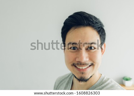 Happy Asian man selfie in his condominium room.