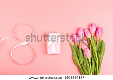 View from above tulips and gift box with copy space. Background for womens day, 8 March Valentines day, 14 february. Flat lay style, top view, mockup, template, overhead. Greeting card