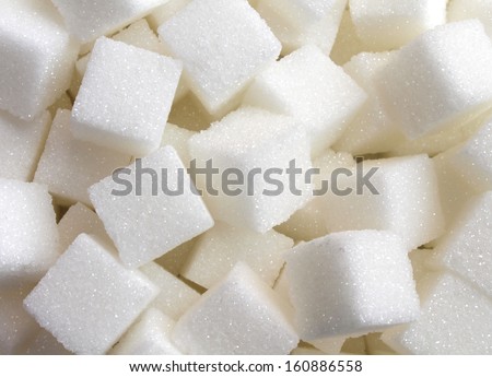 Sugar background sweet food ingredient with a close up of a pile of delicious white lumps of cubes as a symbol of cooking and baking and the diet health risks related to diabetes and calorie intake. Royalty-Free Stock Photo #160886558