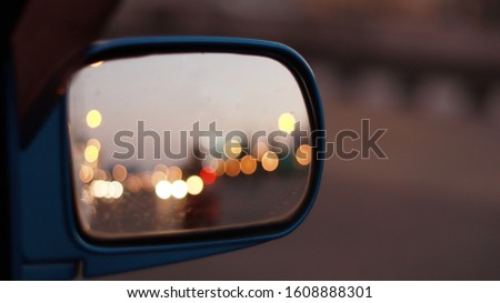 Closeup rear view mirror with bokeh reflection in mirror, beautiful glass view background
