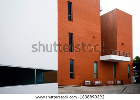 Open White Wall on Side of Orange Building With White Sky - Great for a Sign