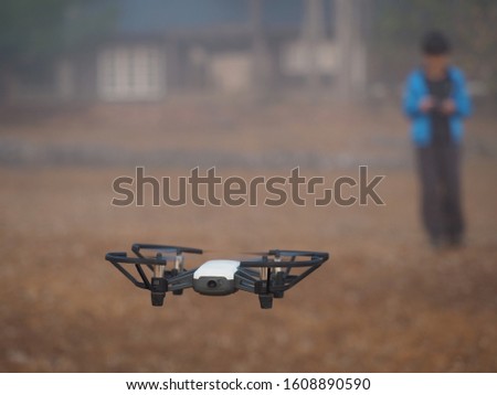 Boy is operate the drone by remote control