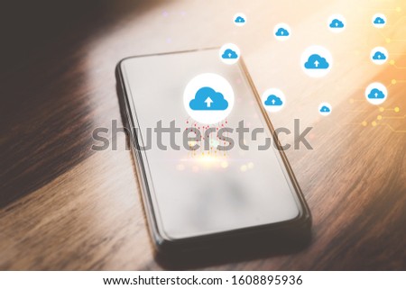 Smart phone on wooden table with clouds icon network at cafe. Copy space of technology business concept.