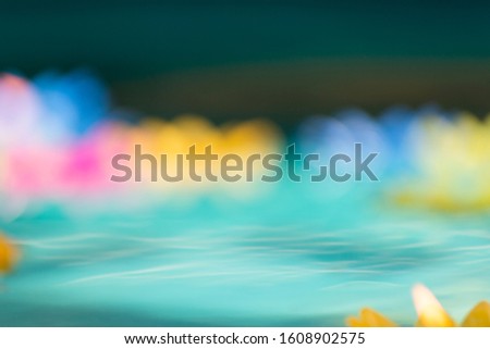 The colorful of Blur lotus candles are floating on the water with vintage.Beatiful Bokeh light Background