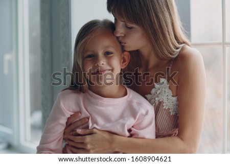 Mother hug with a little daughter. Family and mother's day concept.