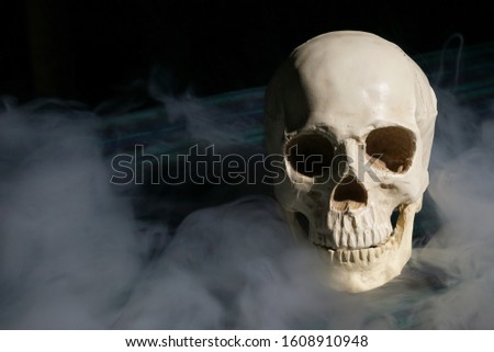 A skull with smoke around it. Smoking kills concept picture.