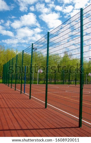 rubberized playgrounds, basketball court - This is a playing surface consisting of a rectangular floor, with baskets at each end.