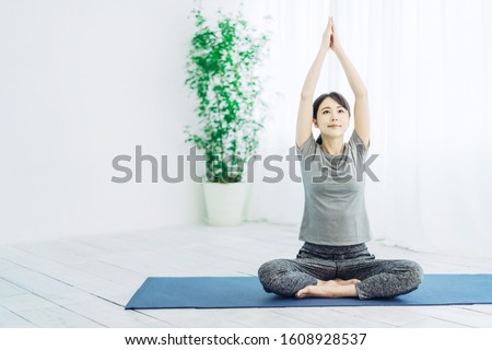 Young asian woman doing yoga.