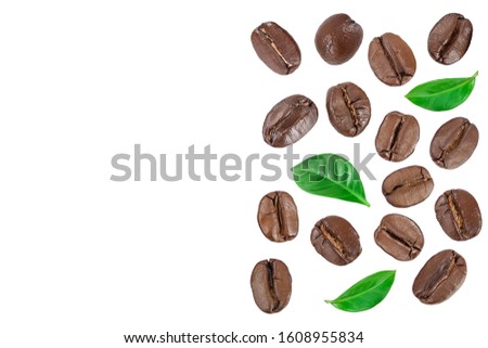 Heap of roasted coffee beans with leaves isolated on white background with copy space for your text. Top view. Flat lay.