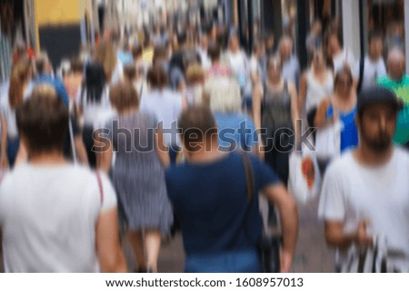 blurred image. Crowd of people walking on the busy city street. Abstract blur pedestrian.