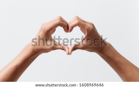 Man hands making a heart shape on a white isolated background Royalty-Free Stock Photo #1608969646
