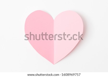Paper elements in shape of heart flying on white paper background. Love and Valentine's day concept. Birthday greeting card design. Royalty-Free Stock Photo #1608969757