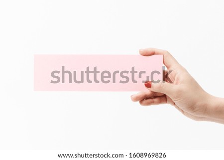 Close up women holding pink blank paper on white background. Free space, ready for type with text banner.