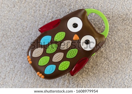 Plastic owl in the shape of a button telephone.