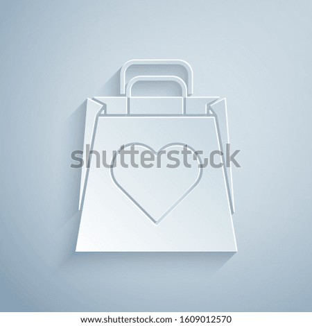 Paper cut Shopping bag with heart icon isolated on grey background. Shopping bag shop love like heart icon. Valentines day symbol. Paper art style. Vector Illustration