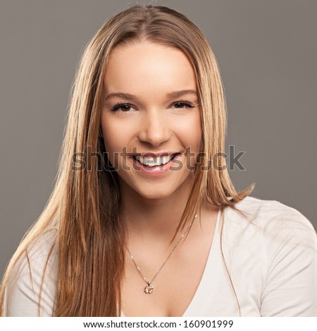 Studio portrait of a beautiful smiling Caucasian woman.