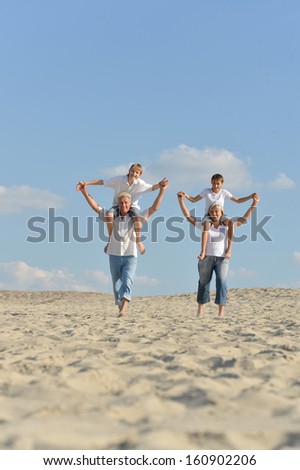 Old couple with their grandsons walking outdoors