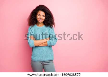 Photo of reliable intelligent woman with arms crossed in grey pants standing near empty space smiling toothily isolated pastel color background