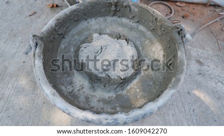 Mixing cement in the small bucket