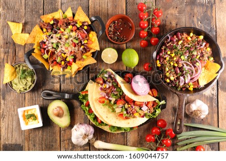 assorted of mexican food with fajitas, chili con carne and nachos with avocado, beef and cheese