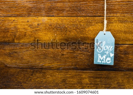 Wooden hanging decoration with text You and Me on wooden background. Romantic, love concept. Valentine`s day. Bucharest, Romania, 2020.