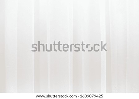 white light curtains with soft folds - horizontal close up photo with selective focus. Perfect background
