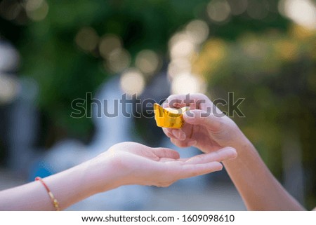 close up holding Golden Medal of the Chinese people,New Year festival, celebration, Festivities concept, selected focus