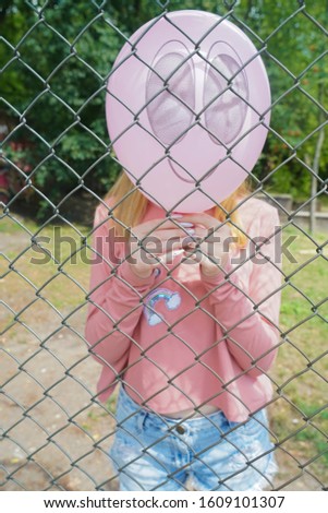 woman with a balloon for a head. smile printed on pink balloon.girl  holding red balloon with smile face emotion instead of head. Positive Thinking concepts. hiding some bad feeling just keep smiling